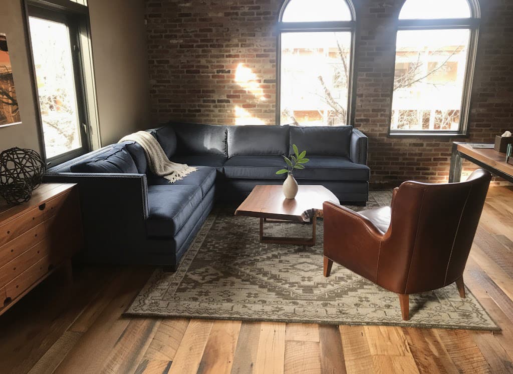 Custom walnut coffee table in modern living room with exposed brick